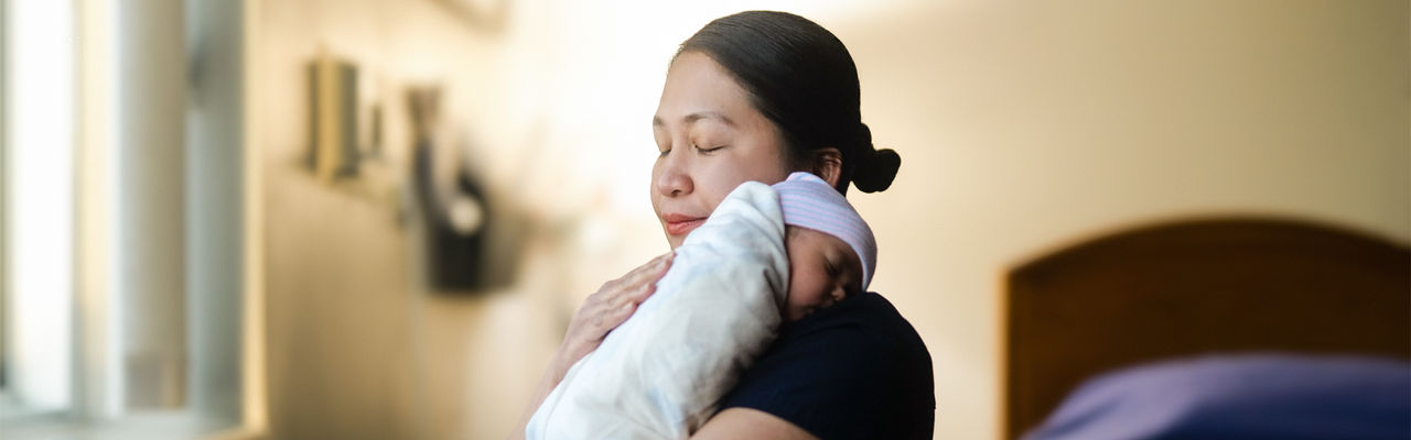 sagewest caregiver holding newborn