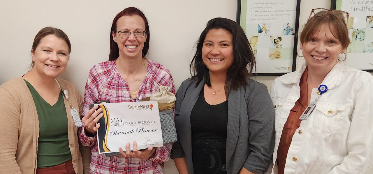 Shannah Plouvier reciving employee of the month certificate