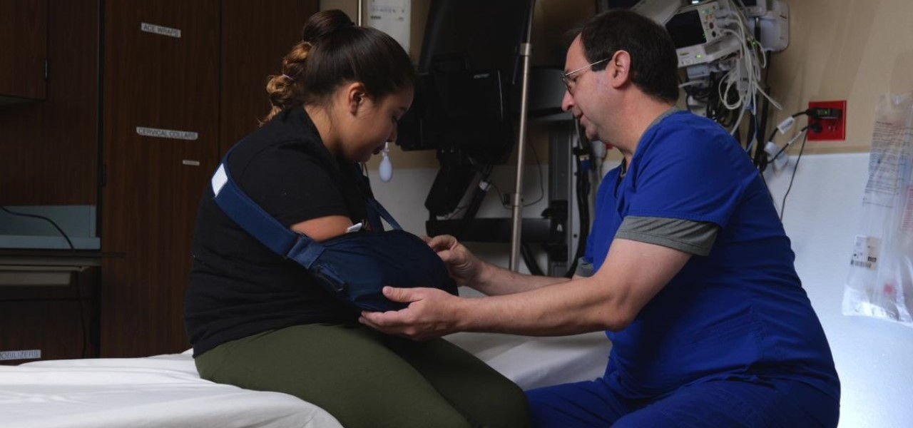 Nurse caring for patient with broken arm