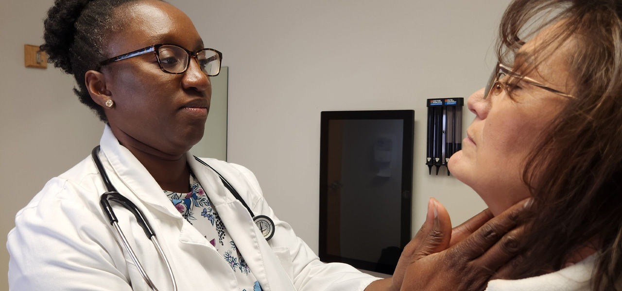 Dr. Mutsa Munjoma works with a patient at Wind River Clinic